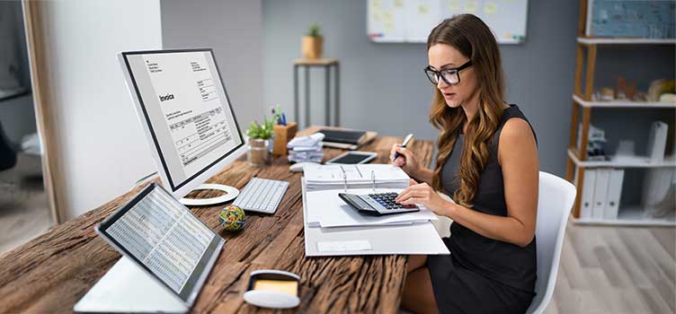 tax accountant works on reconciling clients invoices