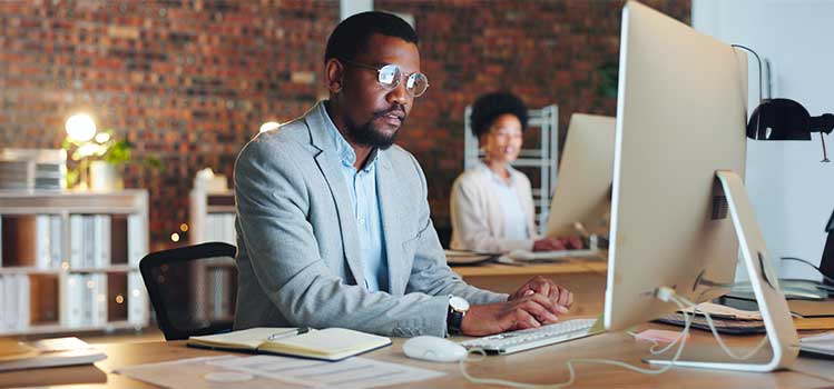 technology accountant works on desktop in IT office