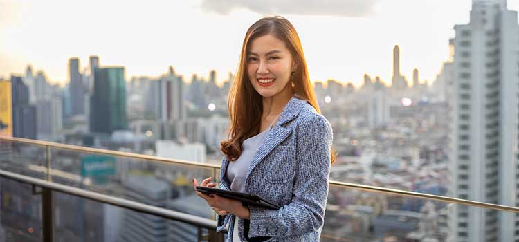 real estate accountant stands in front of cityscape view