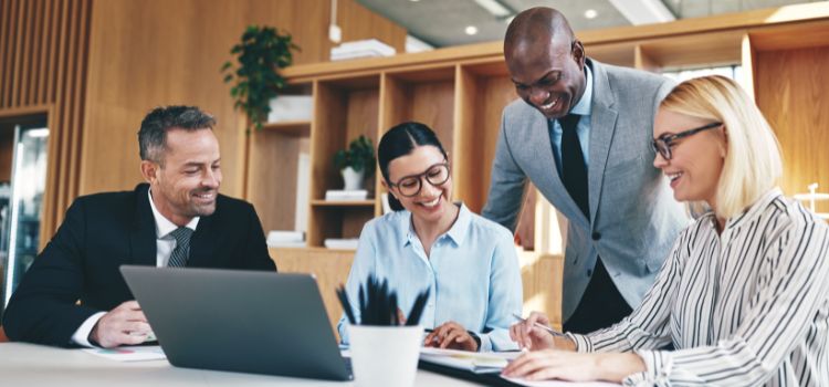 a group of accountants work together in an office meeting room